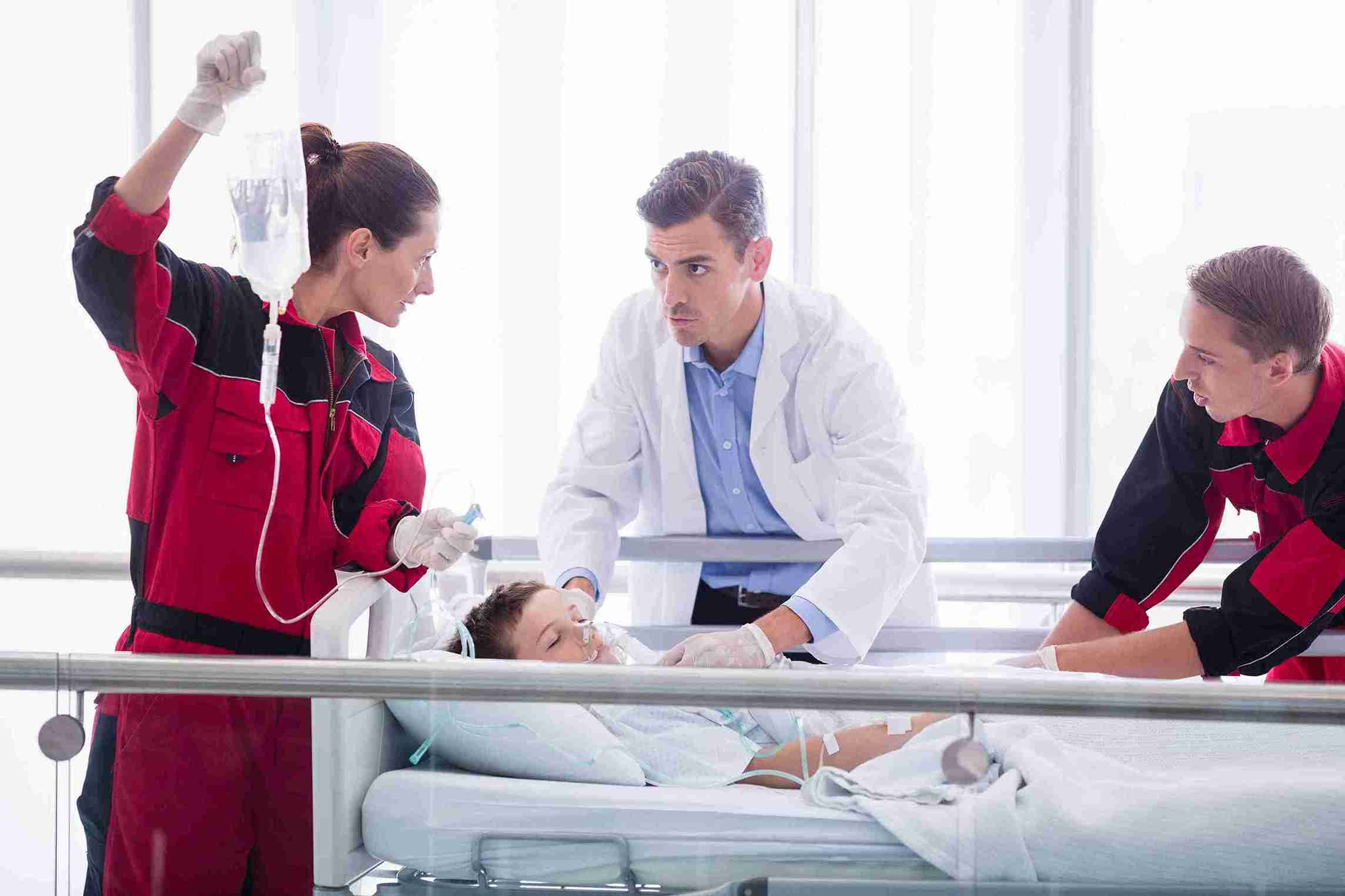 Doctor and Rescue Team Examining the Patient 