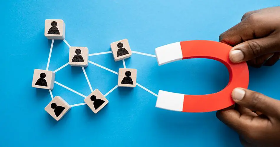 Visual representation of employee retention: A magnet symbolizing retention efforts, attracting a network of individuals depicted on cards
