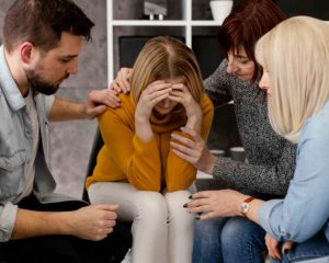 Family Comforting Depressed Woman