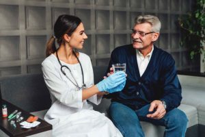 Female Doctor Taking Care of Old Patient