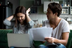 Fustrated Wife Disagreeing With Angry Husband Over Financial Budget