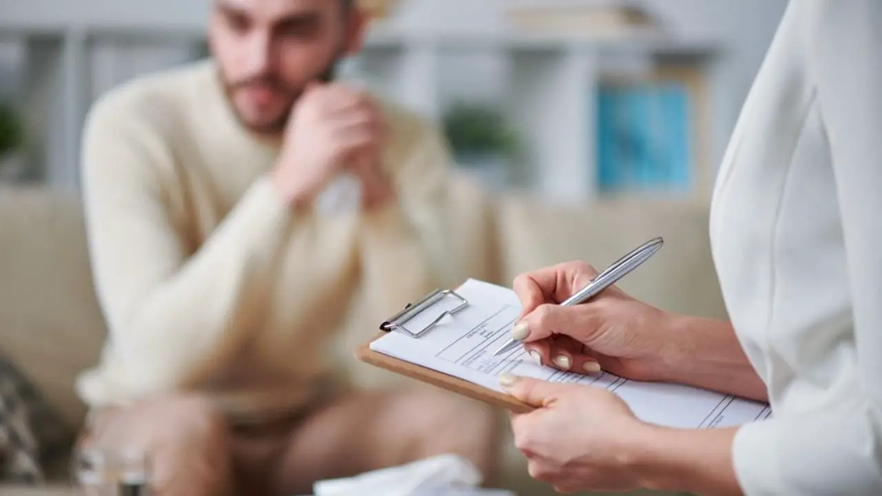 A blurred display shows an individual undergoing therapy...