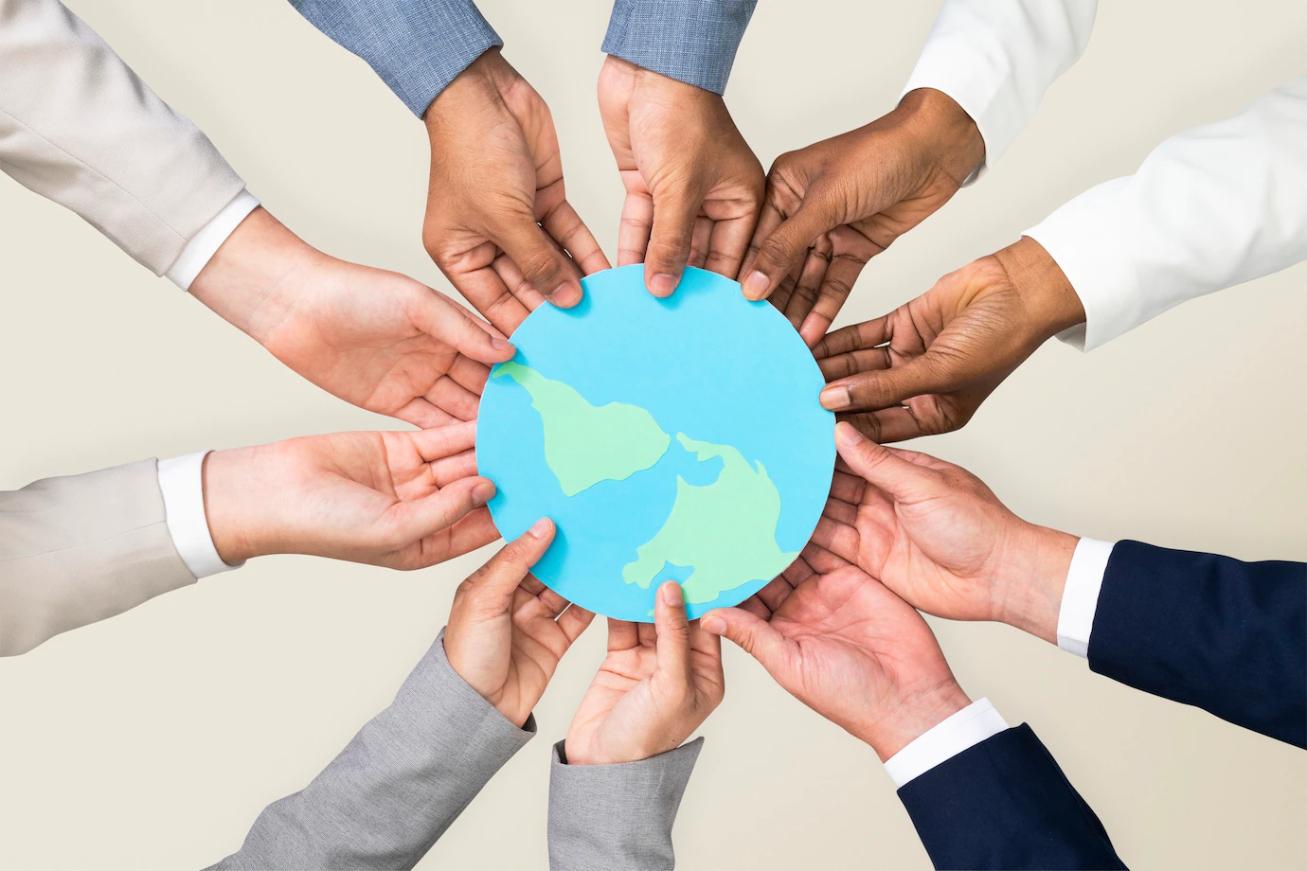 Hands showing different cultural backgrounds holding earth