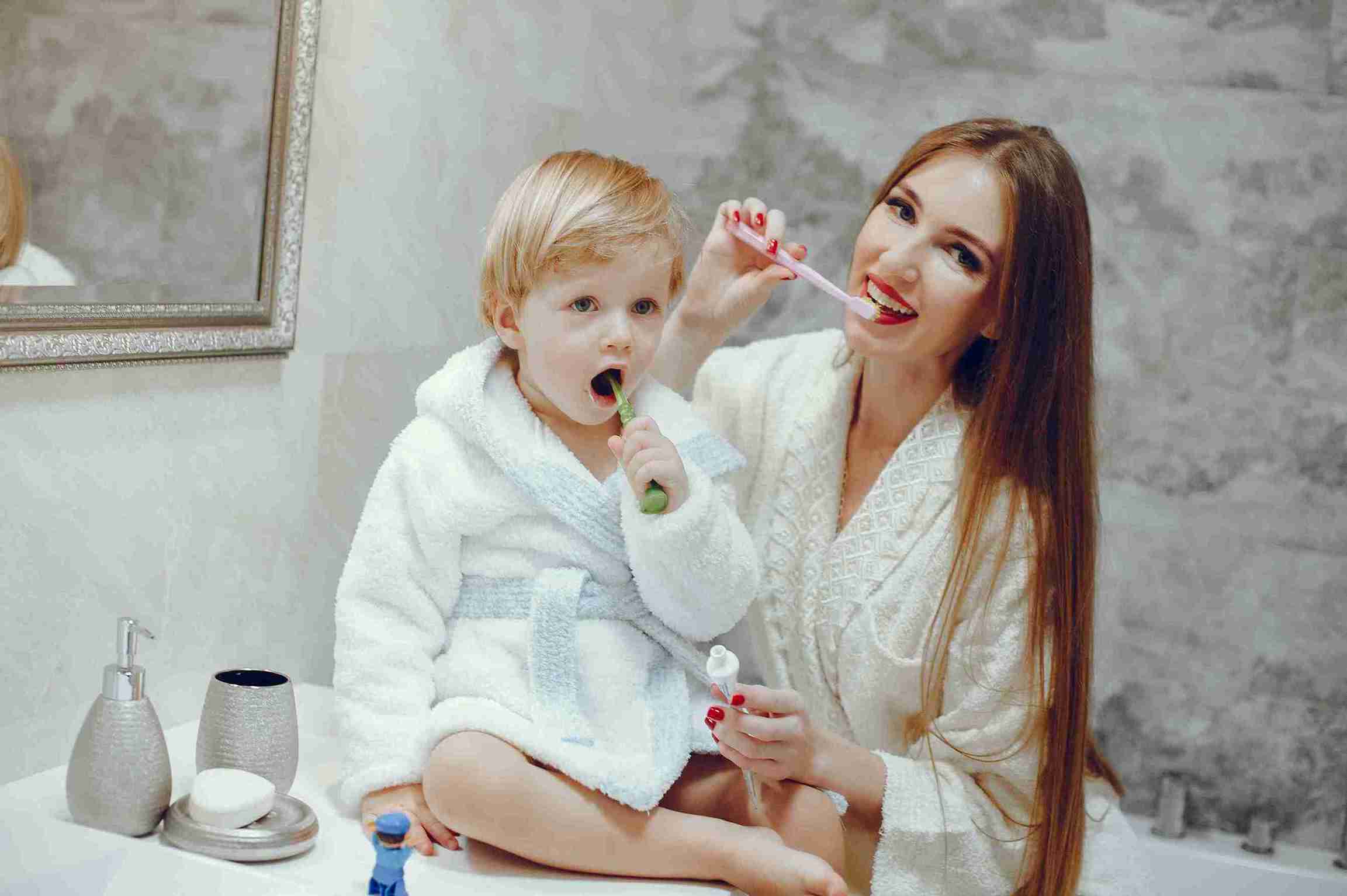 Kid Burshing Teeth With Mother