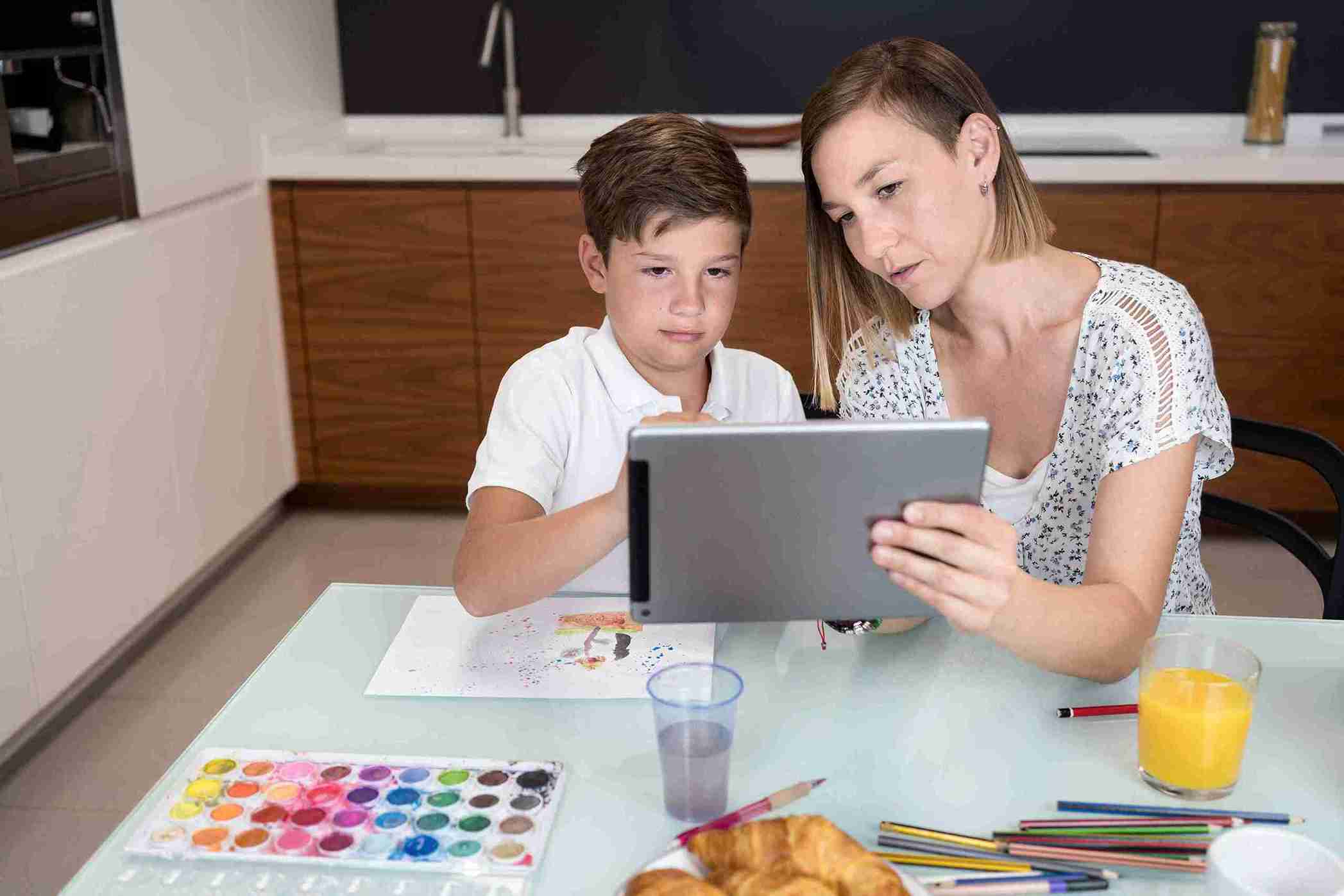 Kid Doing Online Art Project With His Mother