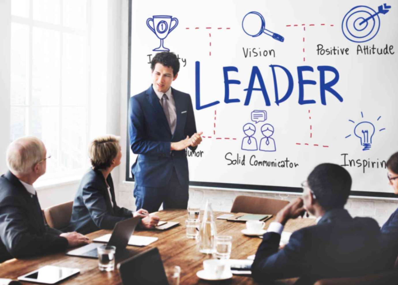 Boss highlighting the importance of change management to his employees in presentation room