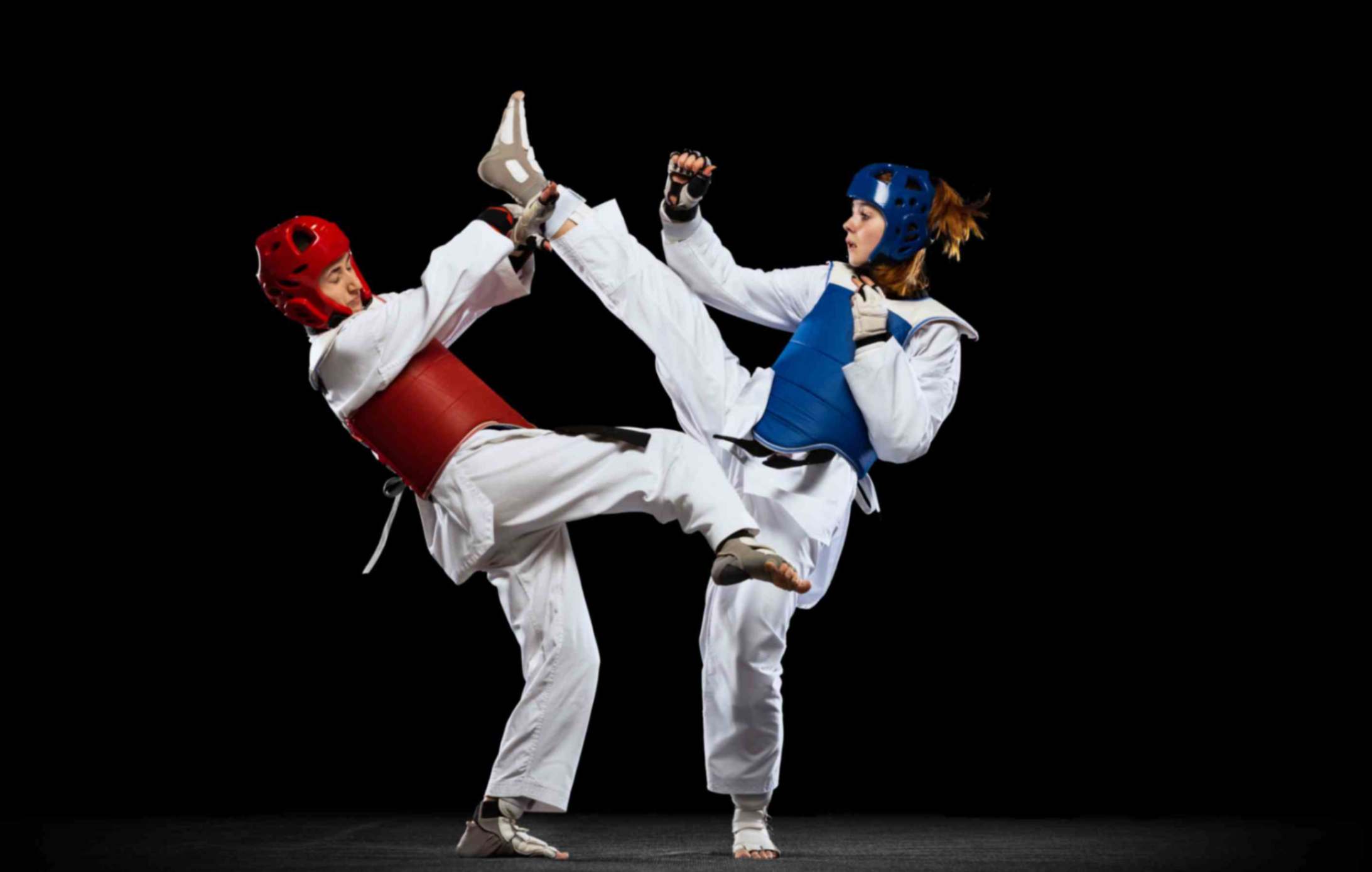 Two women athletes training martial arts