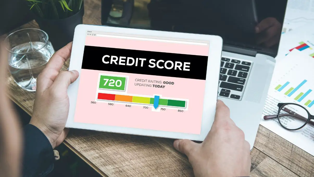 A person checking their good credit score on a tablet