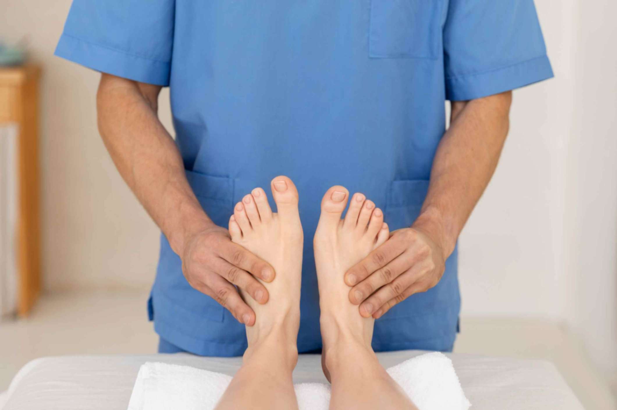 Nurse monitoring patient's feet