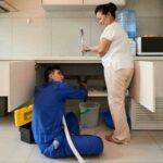 Plumber Fixing Kitchen Pipe