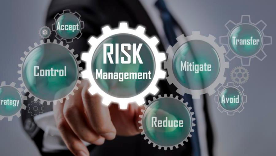 A man in business attire is selecting "Risk Management" from a multitude of options presented on the screen.