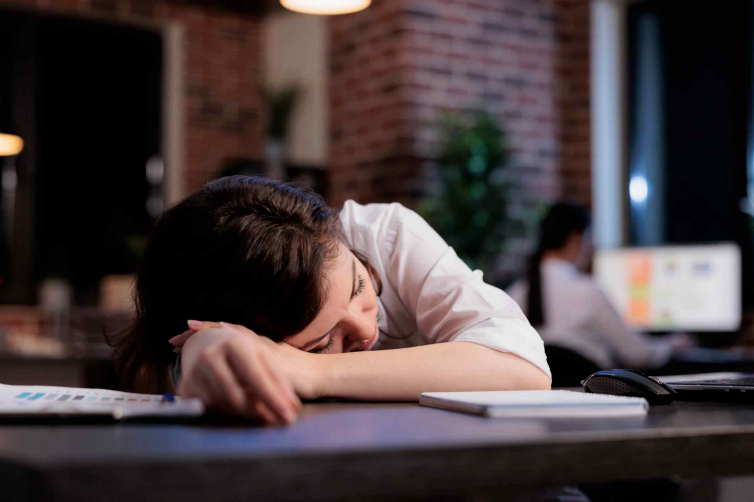 Tired Women From Work Sleeping on Desk