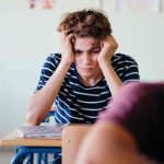 teen find it challenging to concentrate in a noisy classroom