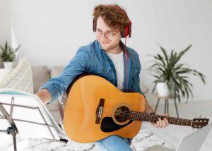teen is playing guitar