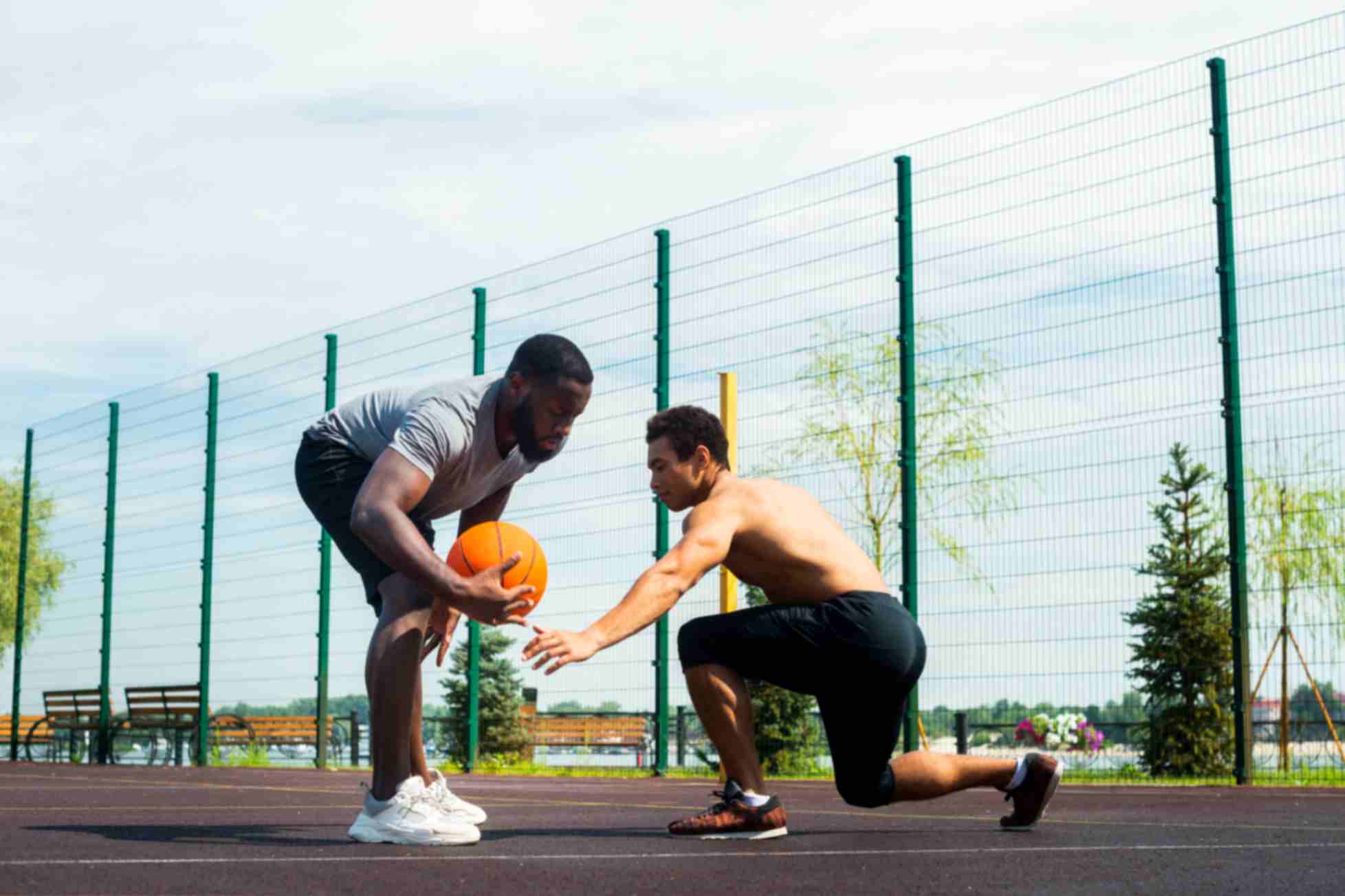 2 men playing long shot urban basketball