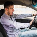 A man giving signal while driving car
