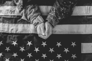 American Soldier Mourning and Prayer on American Flag
