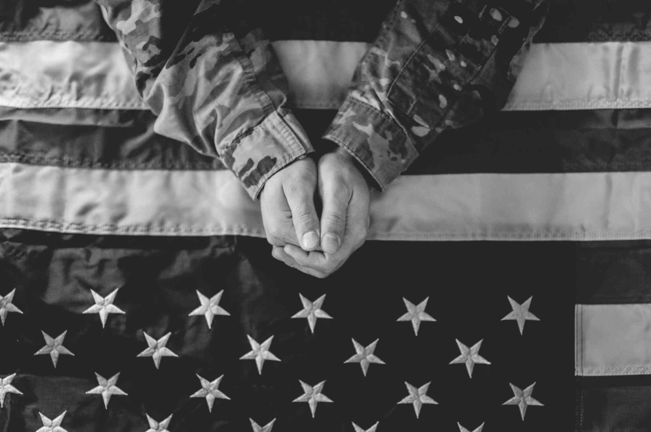 American Soldier Mourning and Prayer on American Flag