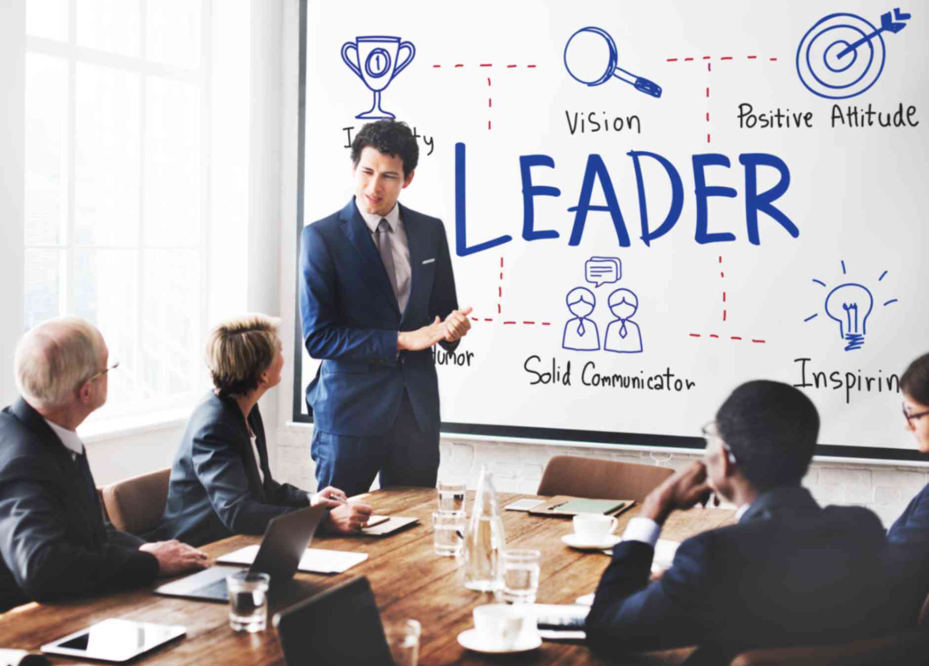 Boss speaking to his employees in meeting room