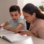 Boy Doing Homework With His Grandmother