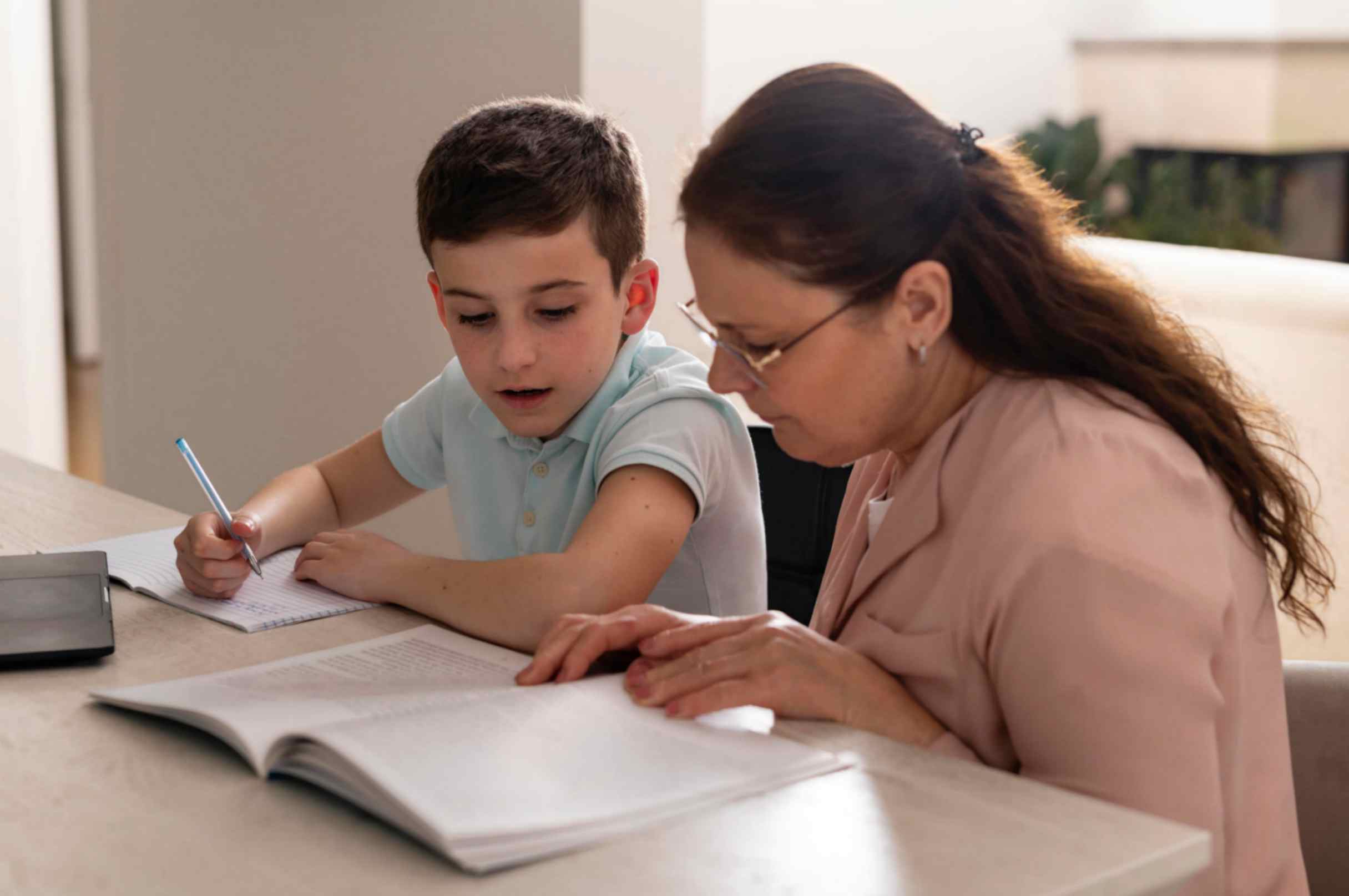 Boy Doing Homework With His Grandmother