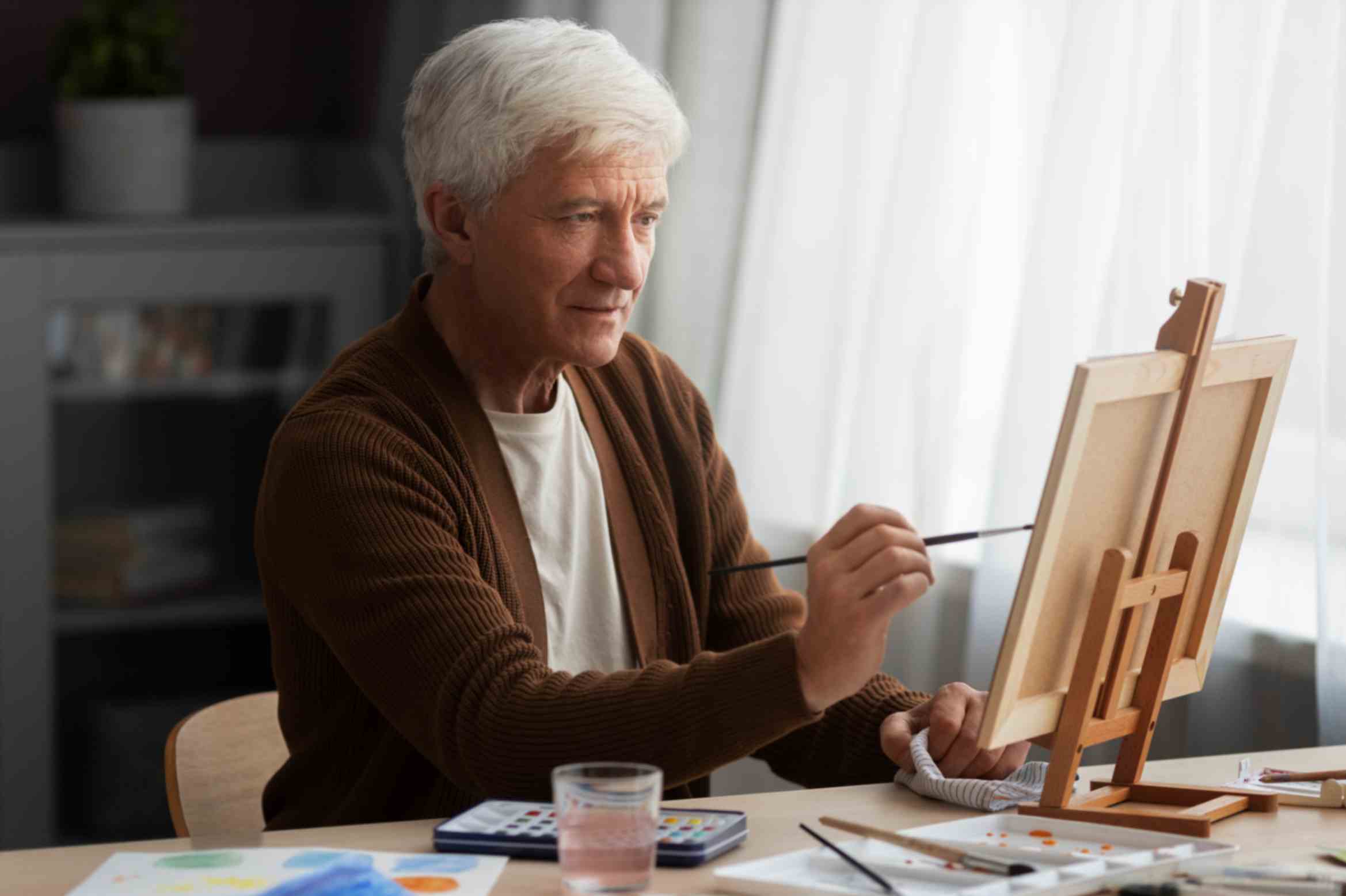 Senior painter using watercolor on his art