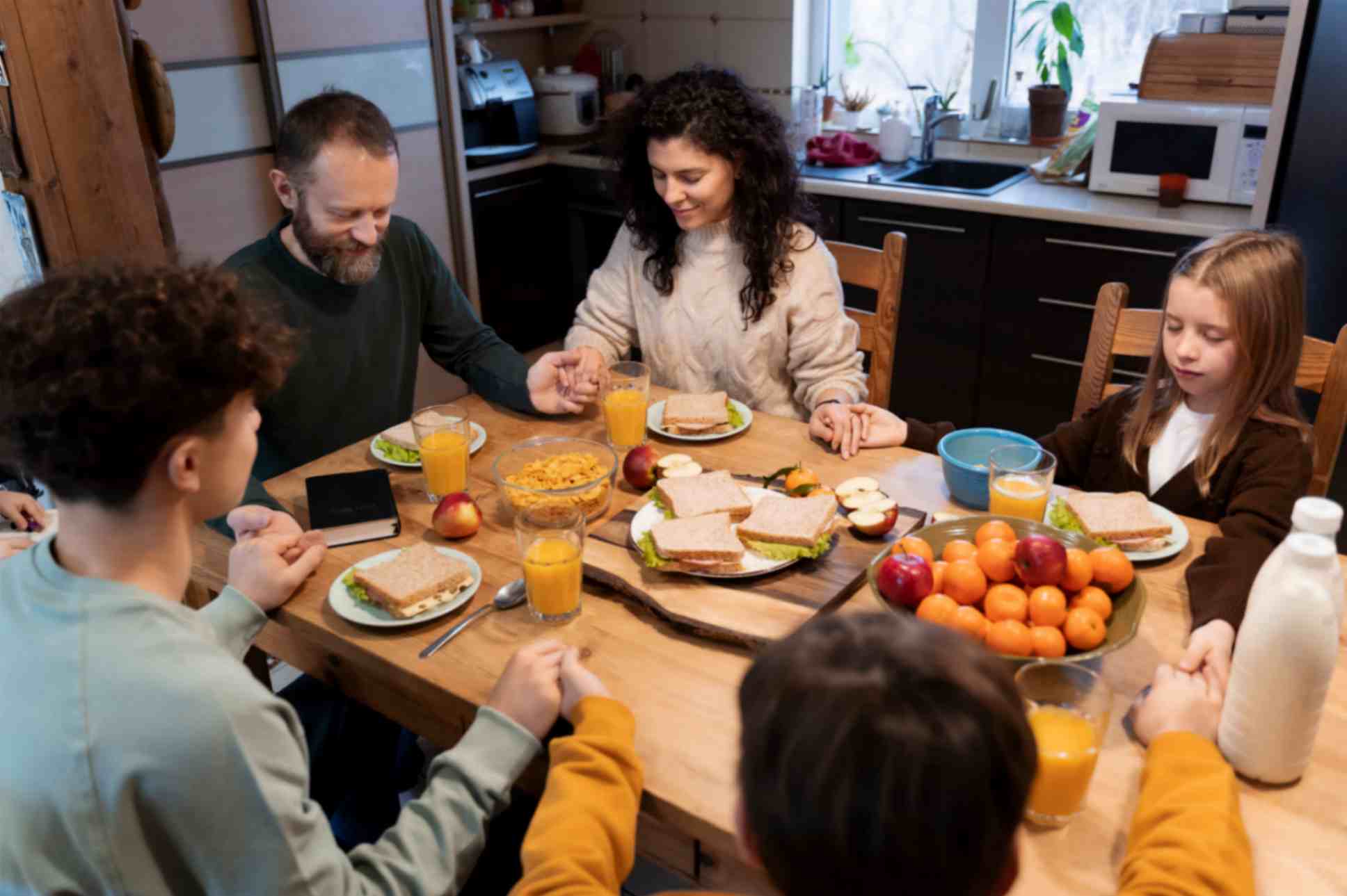 Christain Family Doing Prayer Before Having Food