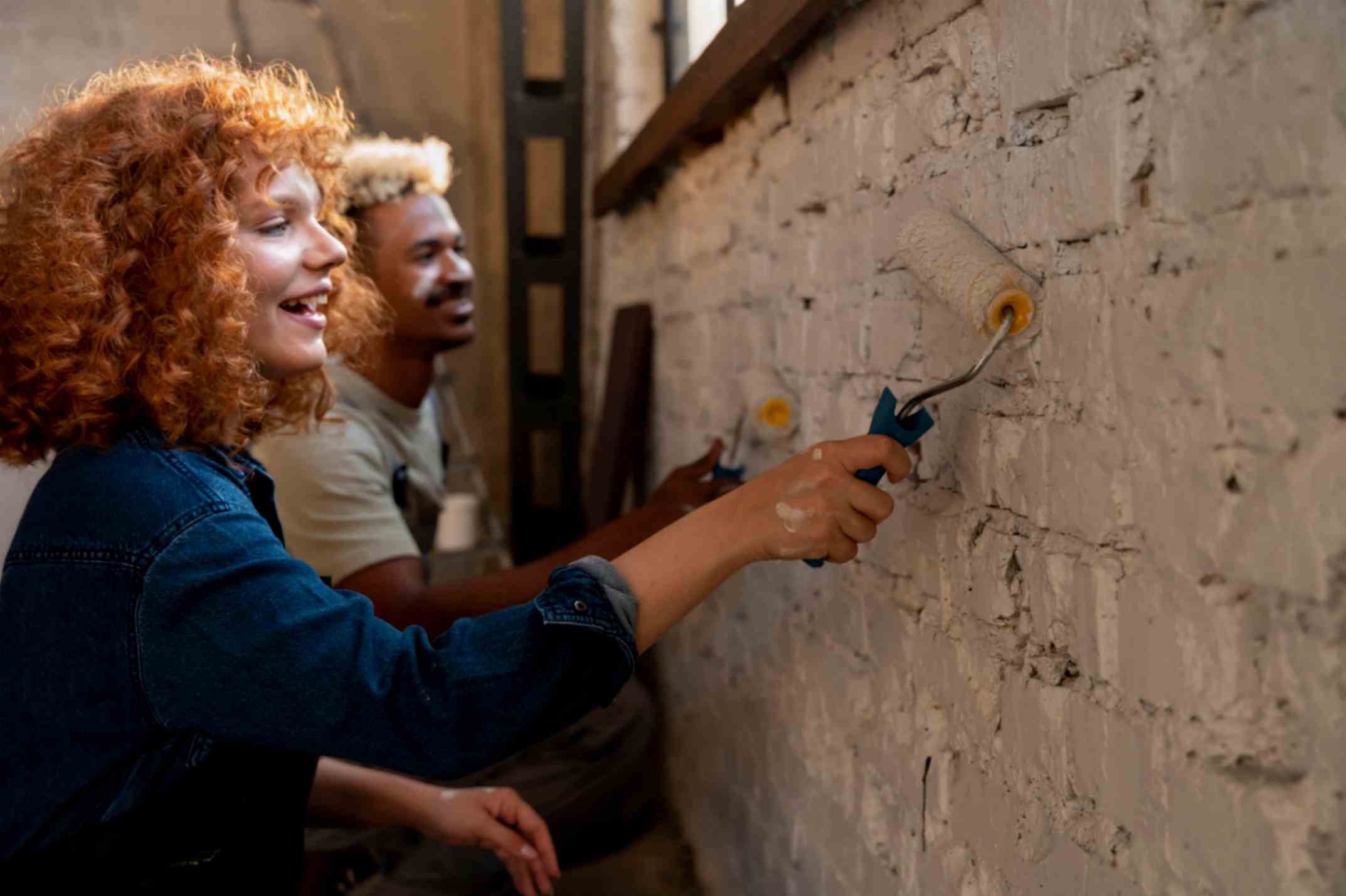 Couple Painting the Wall of Their Home After Cleaning It with SodaBlast
