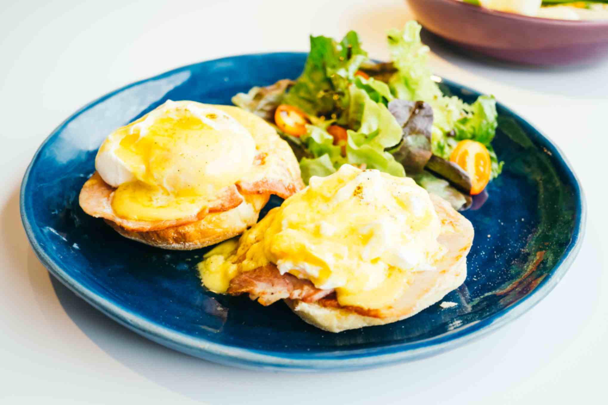 Eggs benedict with ham sauce top