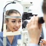 Ophthalmologist examining eyes of a female patient