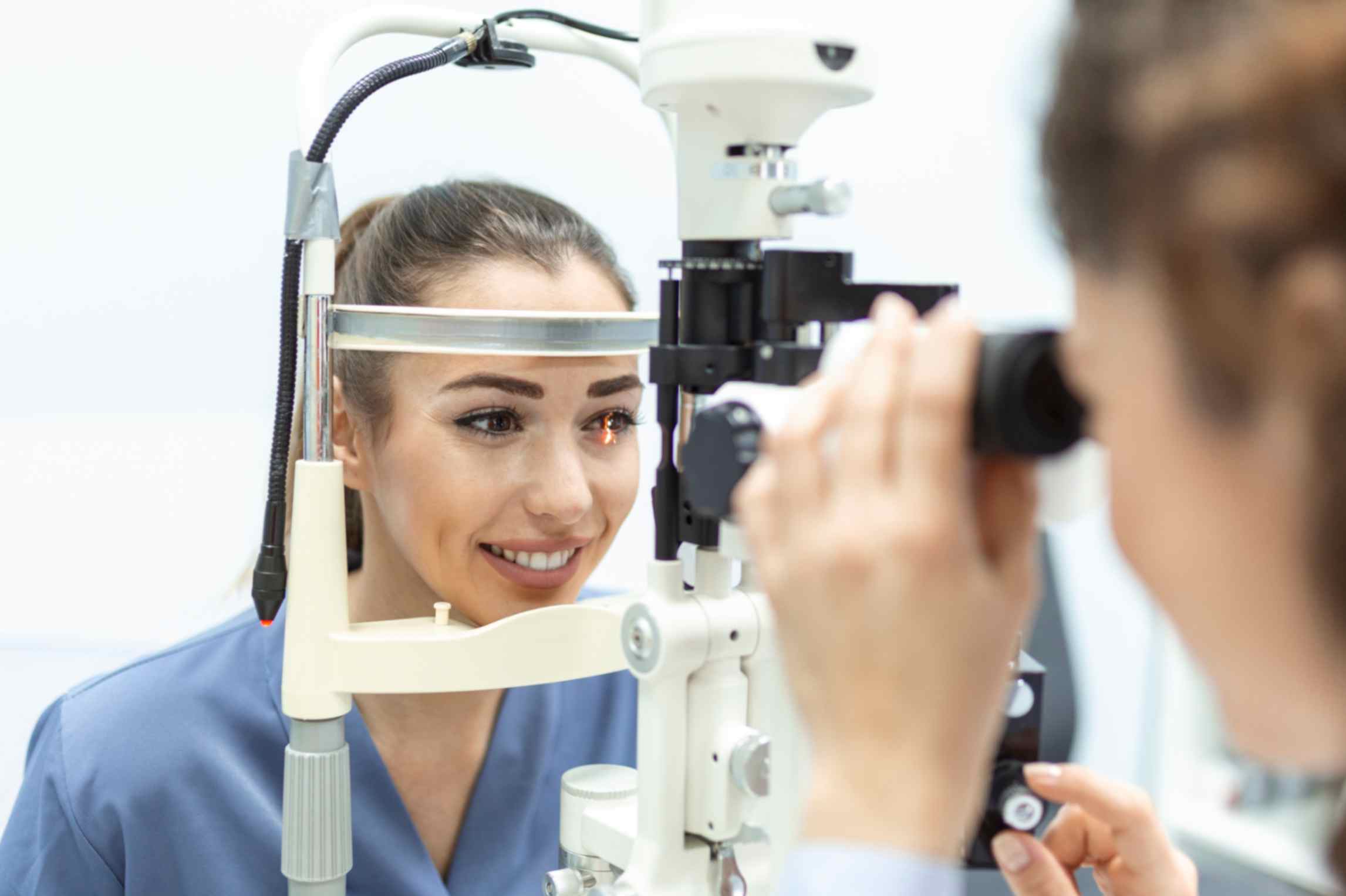 Ophthalmologist examining eyes of a female patient