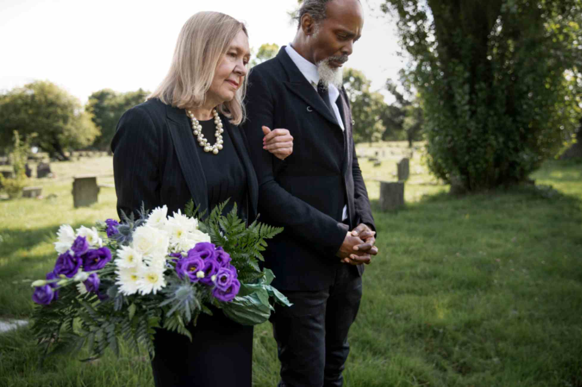 Family visiting grave of a loved-one