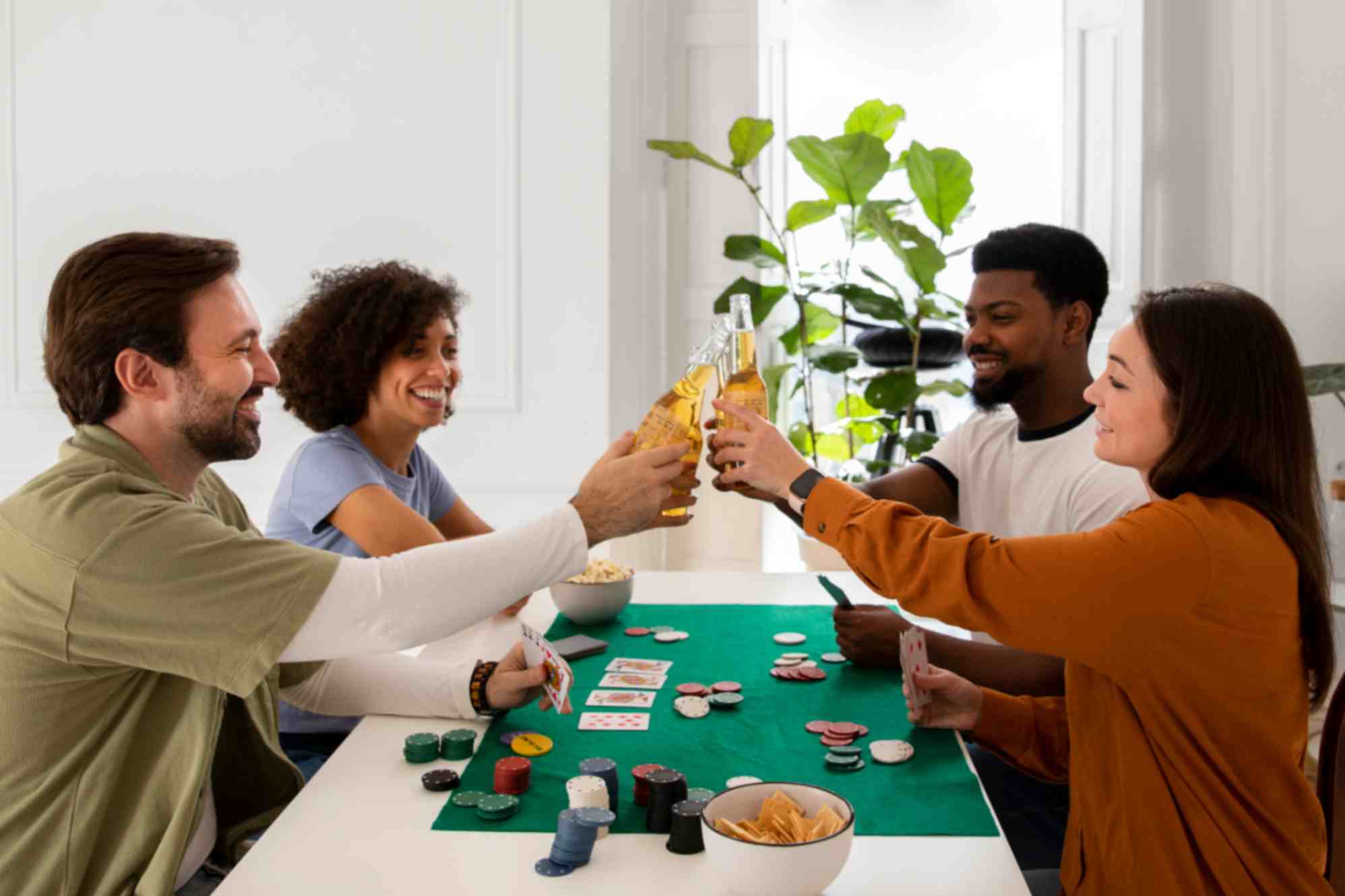Friends playing poker together and having drinks