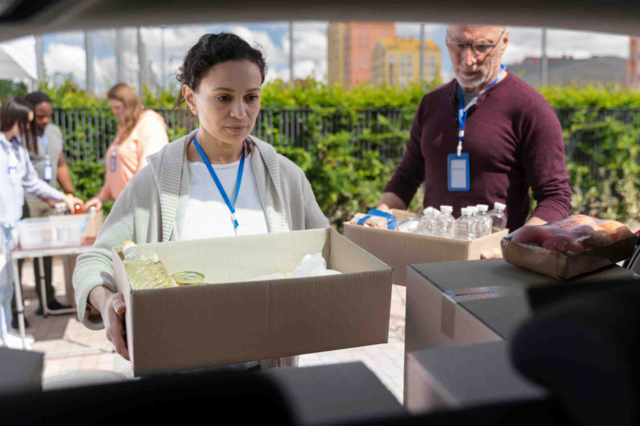 Man and woman volunteering at a foodbank for poor people