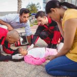 Paramedic staff giving first aid to a little girl