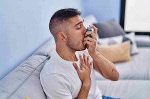 Man Having Asthma Attack Using Inhaler
