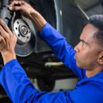 Mechanic fixing car brake