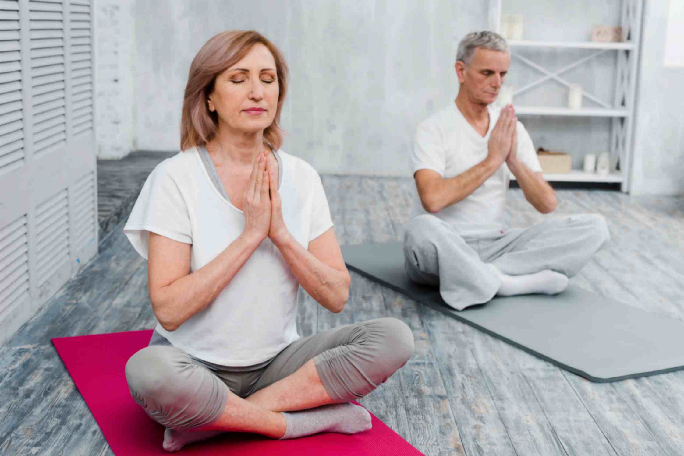Senior Couple Performing Yoga