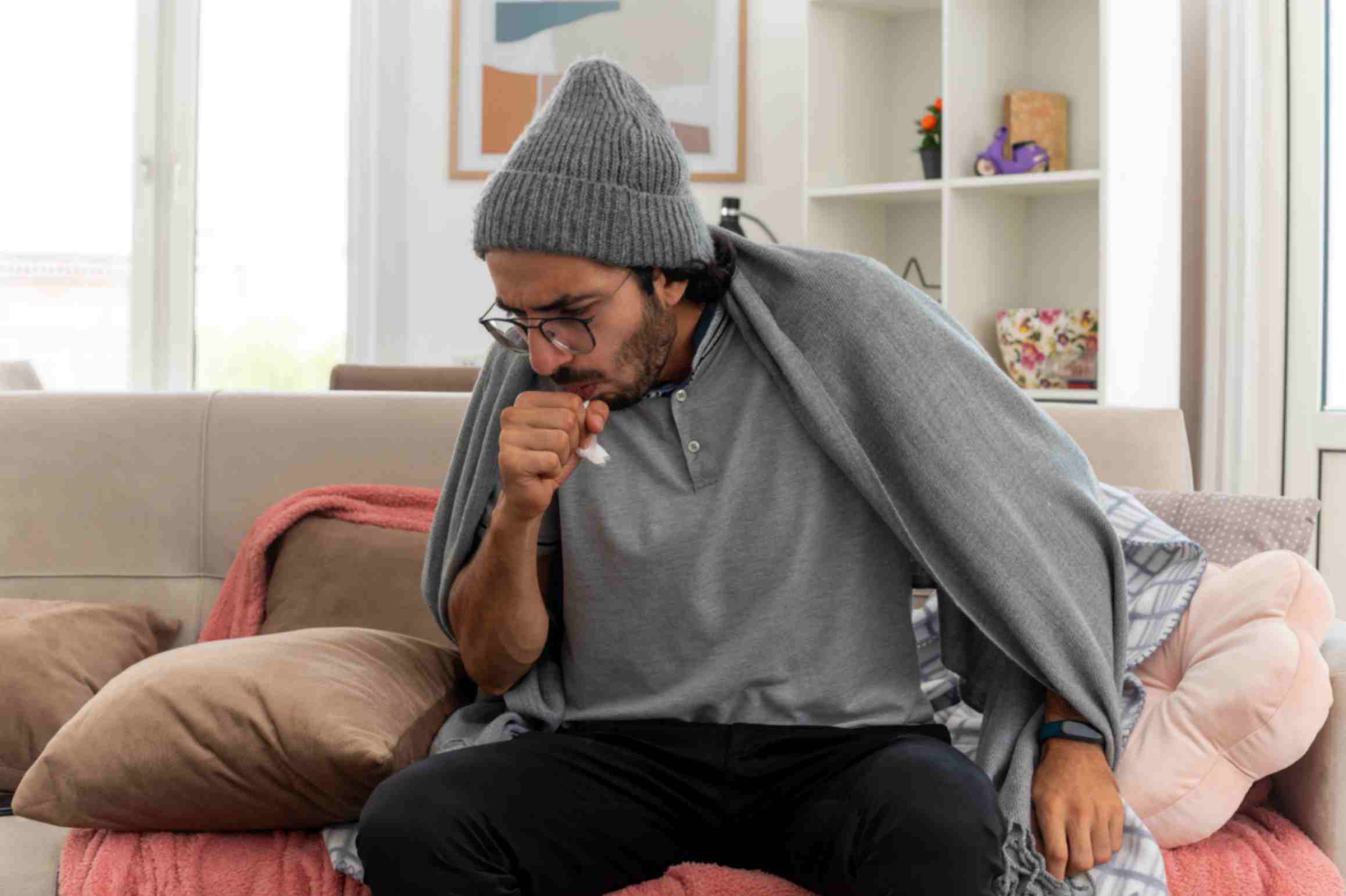 Sick Man is Coughing While Covering His Face