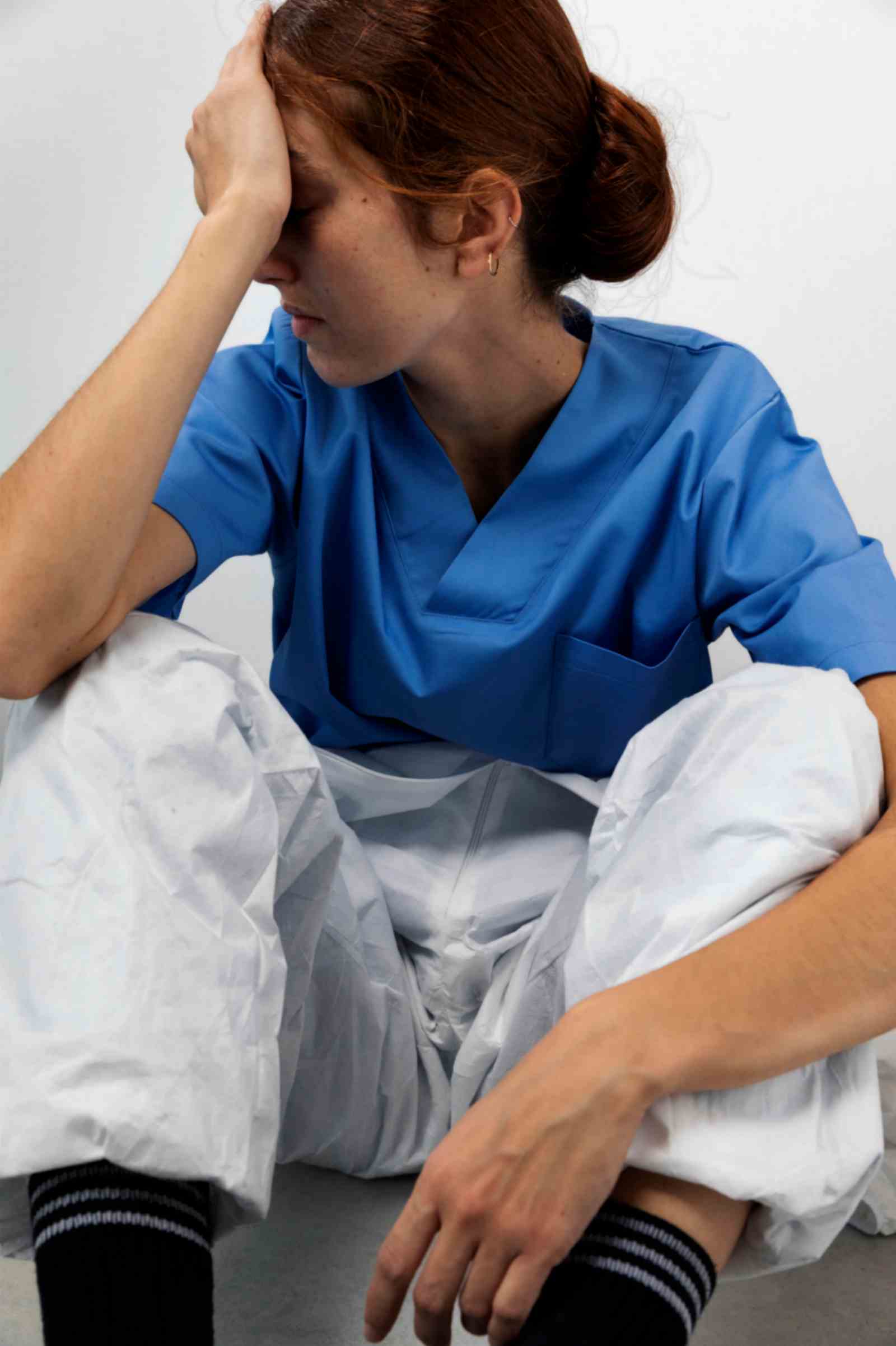 Tired Nurse Sitting on The Floor