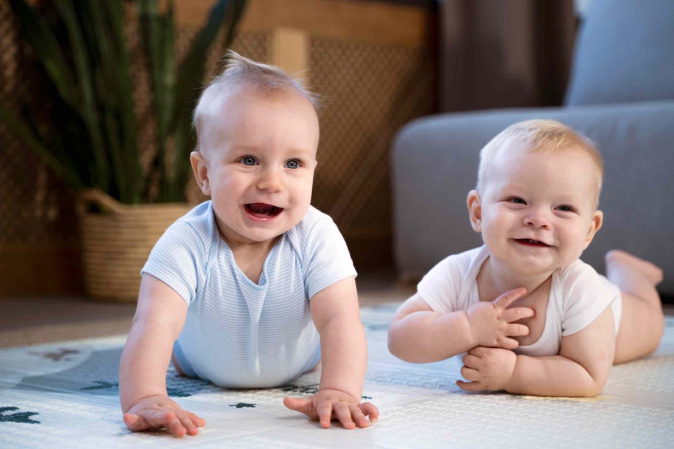 Twin babies crawling on the floor together