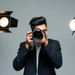 Professional young photographer making videos in studio with light