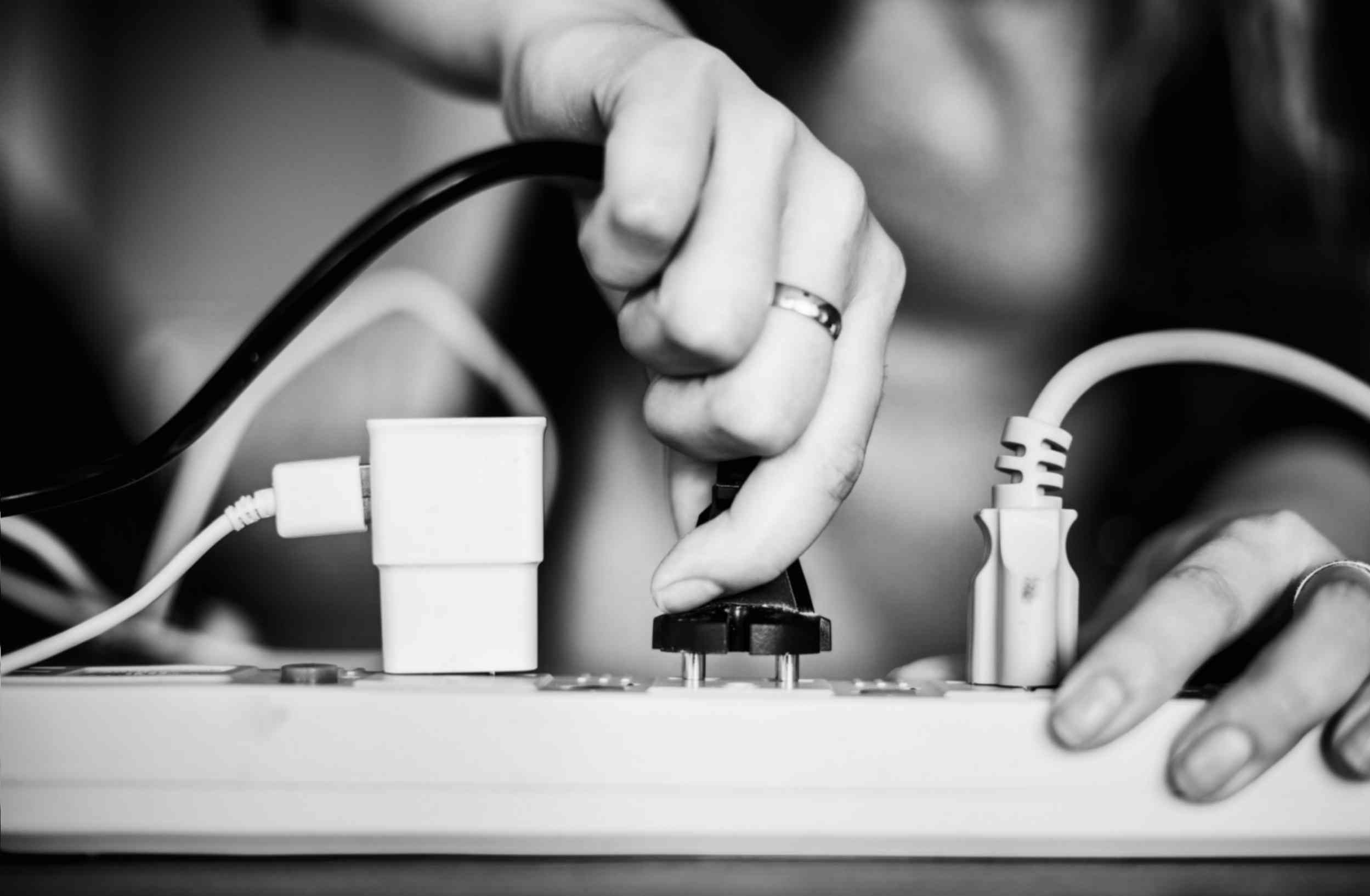 Woman Unplugging Wire
