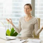 businesswoman relaxing with breath gymnastics