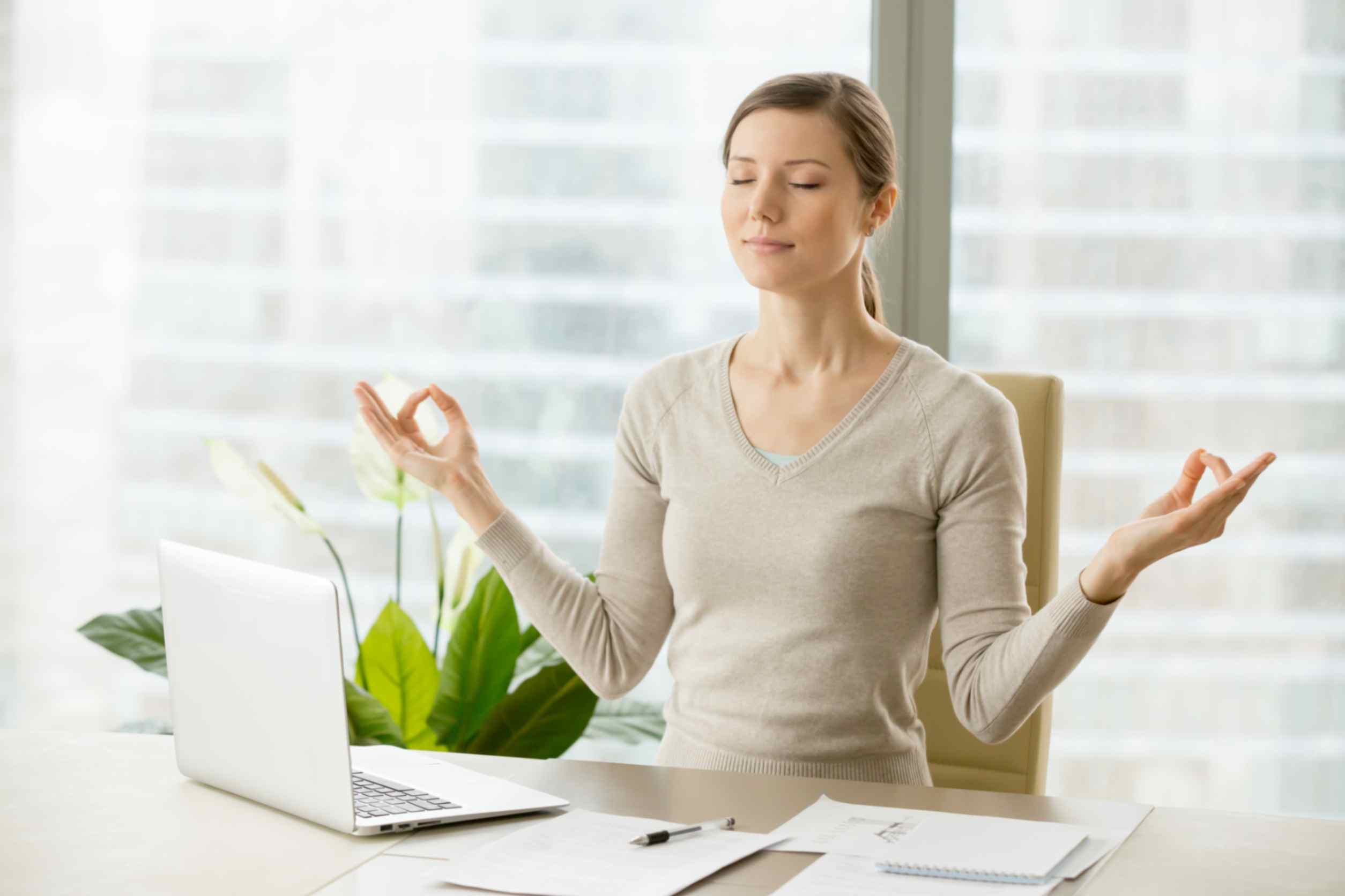 businesswoman relaxing with breath gymnastics