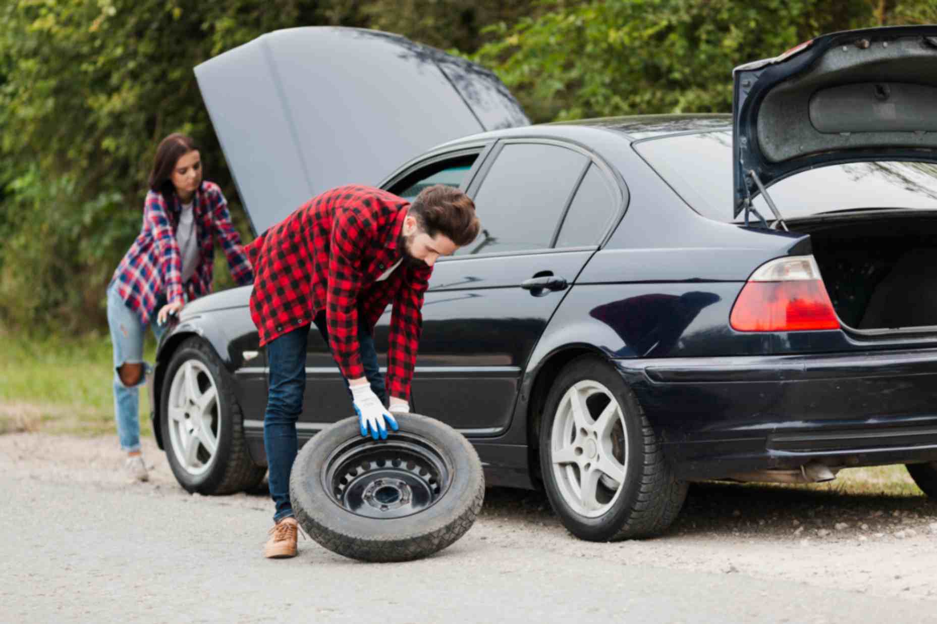 Couple repairing car 