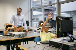 group multiethnic kids wearing vr-headsets teacher watching them