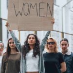 Group of feminist women protesting for their rights outdoors