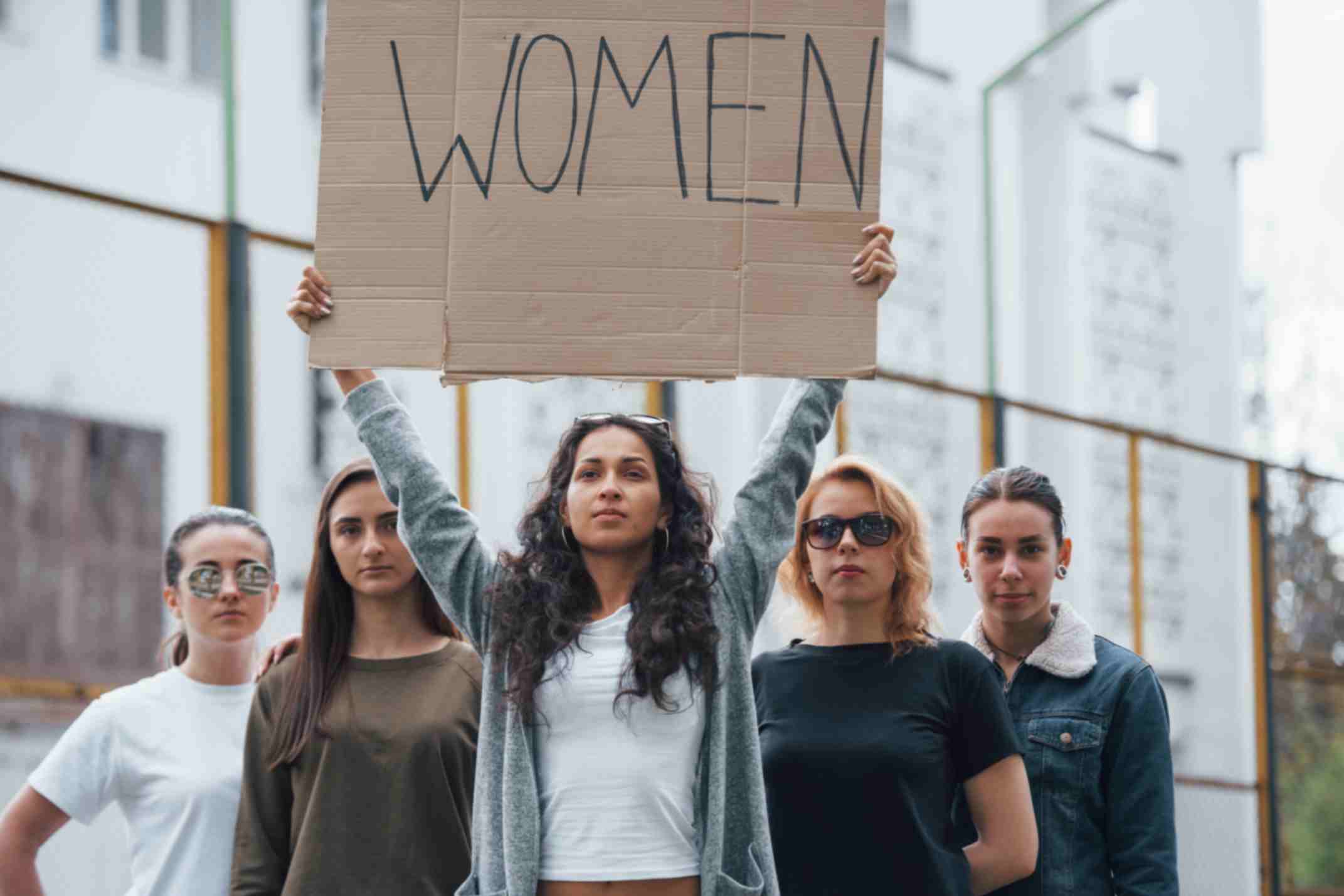 Group of feminist women protesting for their rights outdoors