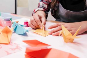 woman hand making creative art craft using origami paper